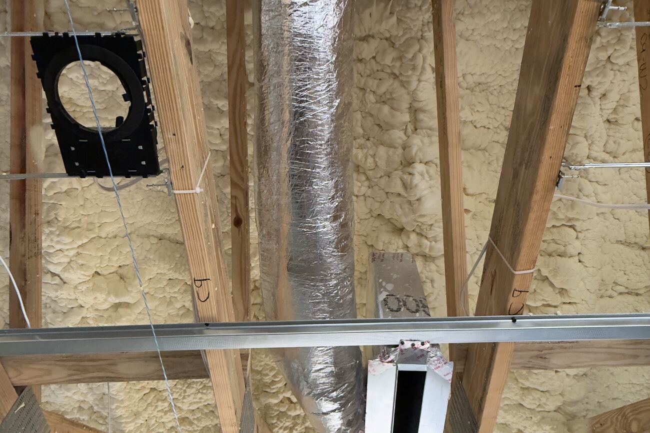 New flex ductwork installed in open ceiling framing