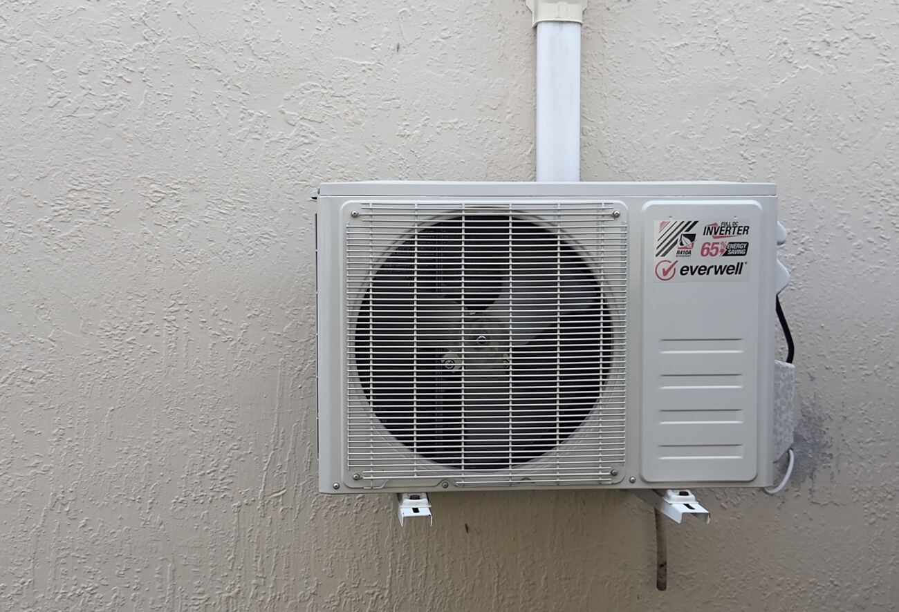 New inverter condenser installed on an exterior wall